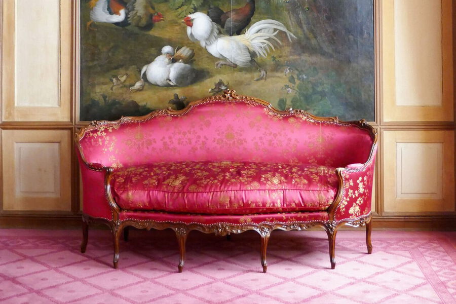 Antikes Sofa mit frischem, roten Bezug
